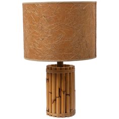 a bamboo lamp with a brown shade on it