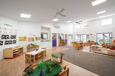 a classroom with tables, chairs and desks is shown in this image from the inside