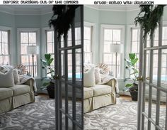 a living room filled with lots of furniture next to two large windows covered in plants