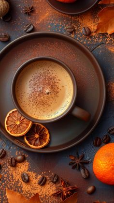 a cup of coffee with orange slices and spices