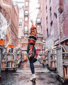 an instagram photo of a woman in the middle of a book store with lots of books