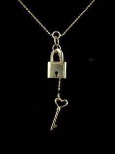 Vintage Designer Gold Over Sterling Lock & Heart Key Necklace 32" Item here is a vintage designer gold over sterling silver lock and heart key necklace. This necklace is marked sterling silver on the tip of the key. This lock and key are functional and the key will open the lock. Necklace closes with a spring ring. Super interesting design with the chain broken into sections and working lock and key.  Top quality! Designer Made in Italy. This designer created designs in horses, snakes, goth and other equestrian jewelry. Very well made.   Sample/New Old Stock!  Condition: Great; item is pre-owned and may have some signs of light use and age related wear. Please look closely at the pictures provided as they are an extension of our written description. Measurements: Length: 32 in Chain Width: Gold Pendant Jewelry With Keys, Lock Jewelry, Equestrian Jewelry, Lock Necklace, Heart Key, Heart And Key, Interesting Design, Key Necklace, Lock And Key