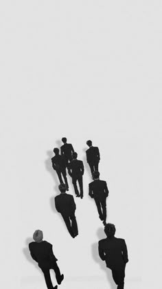 several silhouettes of men walking in the same direction on a white background with one man standing out from the crowd