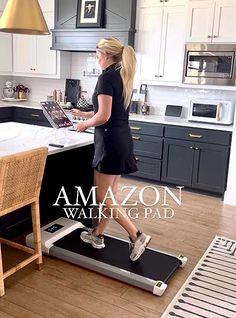 a woman is walking on a treadmill in the kitchen