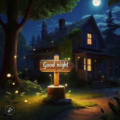 a wooden sign that says good night in front of a house at night with lights on