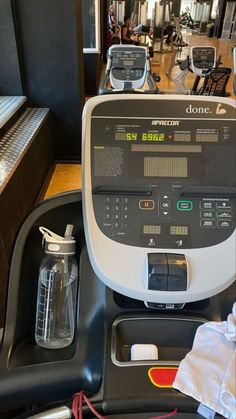 a machine that is sitting on top of a table next to some bottles and other items