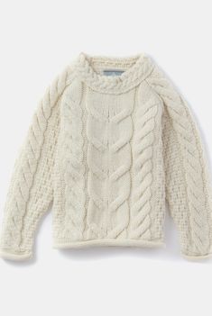 a white sweater with cable kniting on the shoulders and sleeves, sitting on a white surface