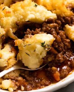 a close up of a plate of food with mashed potatoes