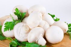 mushrooms and parsley on a wooden cutting board