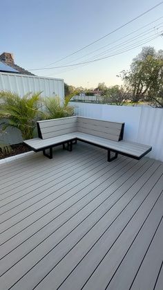 two benches sitting on top of a wooden deck