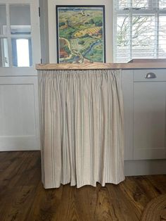 a kitchen counter with a painting on it next to a sink and dishwasher