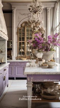 a kitchen with purple cabinets and chandelier