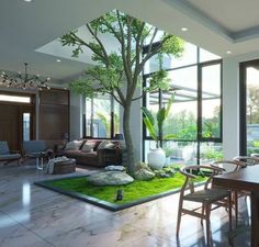 a living room filled with furniture and a tree in the middle of it's floor