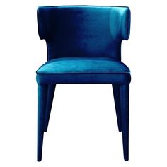 a blue velvet chair on a white background