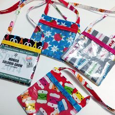 three small purses are lined up next to each other on a white table top