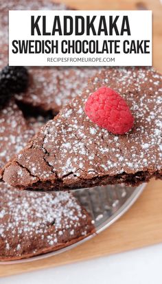 chocolate cake with raspberries on top and the words kladdaka swedish chocolate cake