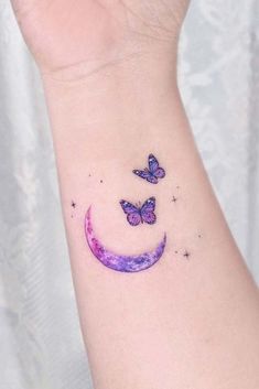 a woman's wrist with a butterfly tattoo on the left side of her arm