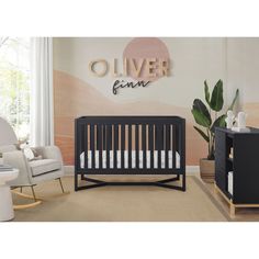 a baby's room with a crib, rocking chair and table