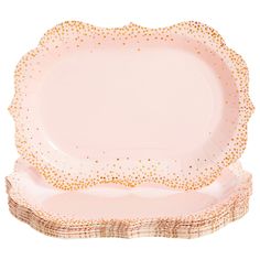 two pink plates with gold dots on the rim and one has a white plate underneath it