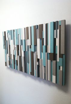 an abstract painting on the wall with blue and gray strips