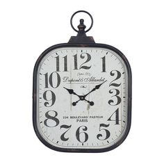 an old fashioned clock is hanging on the wall, with numbers in black and white