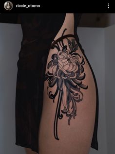 a woman's thigh with a flower tattoo on it