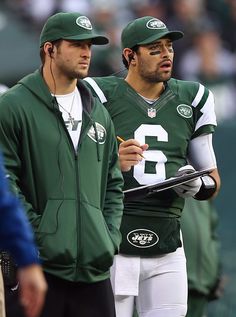 two new york jets football players standing next to each other