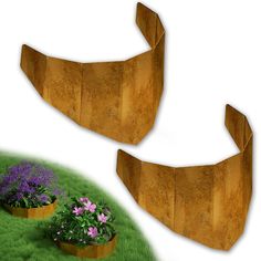 two wooden planters sitting on top of a green grass covered field next to flowers