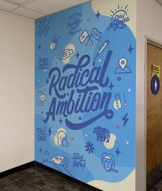 a mural on the wall in an office building reads radical ambition and features doodles