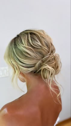 a woman with blonde hair in a low bun