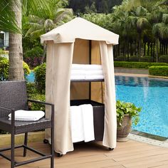 a canopy bed next to a swimming pool