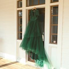 a dress hanging on the front door of a house