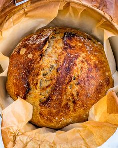 a loaf of bread sitting inside of a paper bag