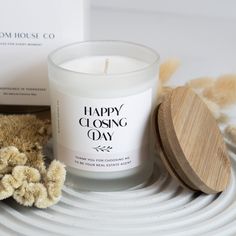 a white candle sitting on top of a table next to a wooden box and a stuffed animal