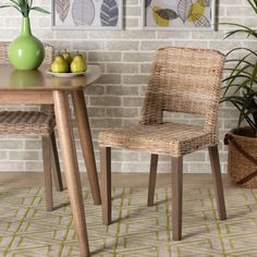 two wicker chairs sitting next to each other near a table with fruit on it