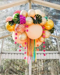 balloons and flowers are hanging from the ceiling