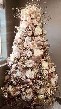 the christmas tree is decorated with flowers and ornaments