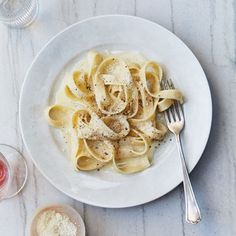 a white plate topped with pasta and sauce