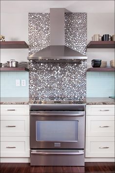 a stove top oven sitting inside of a kitchen next to white cabinets and open shelves