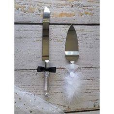 a knife and fork with a black bow on it