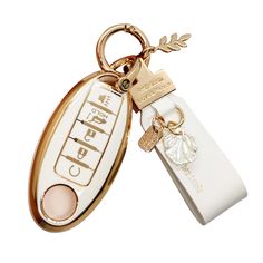 a white and gold keychain with a tag attached to it's side