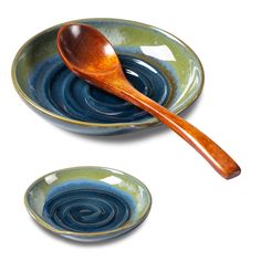 a wooden spoon sitting on top of a bowl next to another bowl filled with liquid