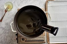 an empty frying pan sitting on top of a stove next to a spatula