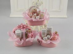 three pink baskets filled with baby items on top of a table