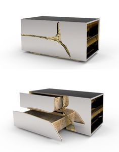 two white boxes with gold designs on the top and bottom, one is open to reveal an object inside