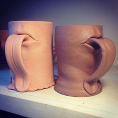 two coffee mugs sitting on top of a counter