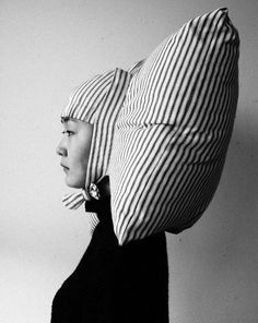 black and white photograph of a woman's head with a pillow on her head