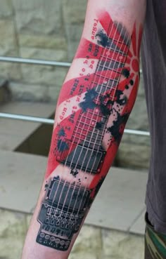 a man with a guitar tattoo on his arm