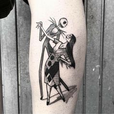 a tattoo on the leg of a woman with a skeleton holding a bow and arrow