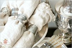 an assortment of silverware sitting on top of a table